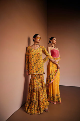 Yellow floral printed kurta paired with gharara and pink dupatta.