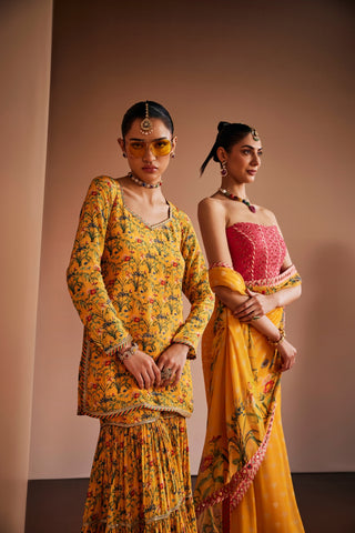 Yellow floral printed kurta paired with gharara and pink dupatta.