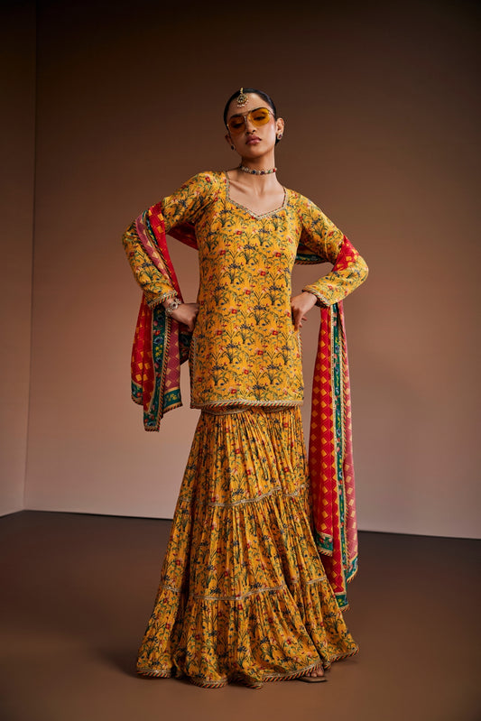Yellow floral printed kurta paired with gharara and pink dupatta.