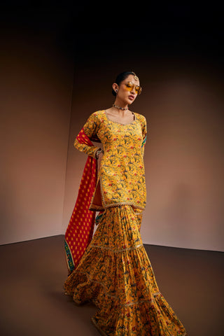 Yellow floral printed kurta paired with gharara and pink dupatta.