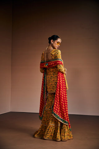 Yellow floral printed kurta paired with gharara and pink dupatta.