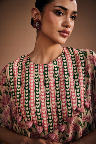 Floral printed kurta paired with striped pants and delicate heart shape tassels.